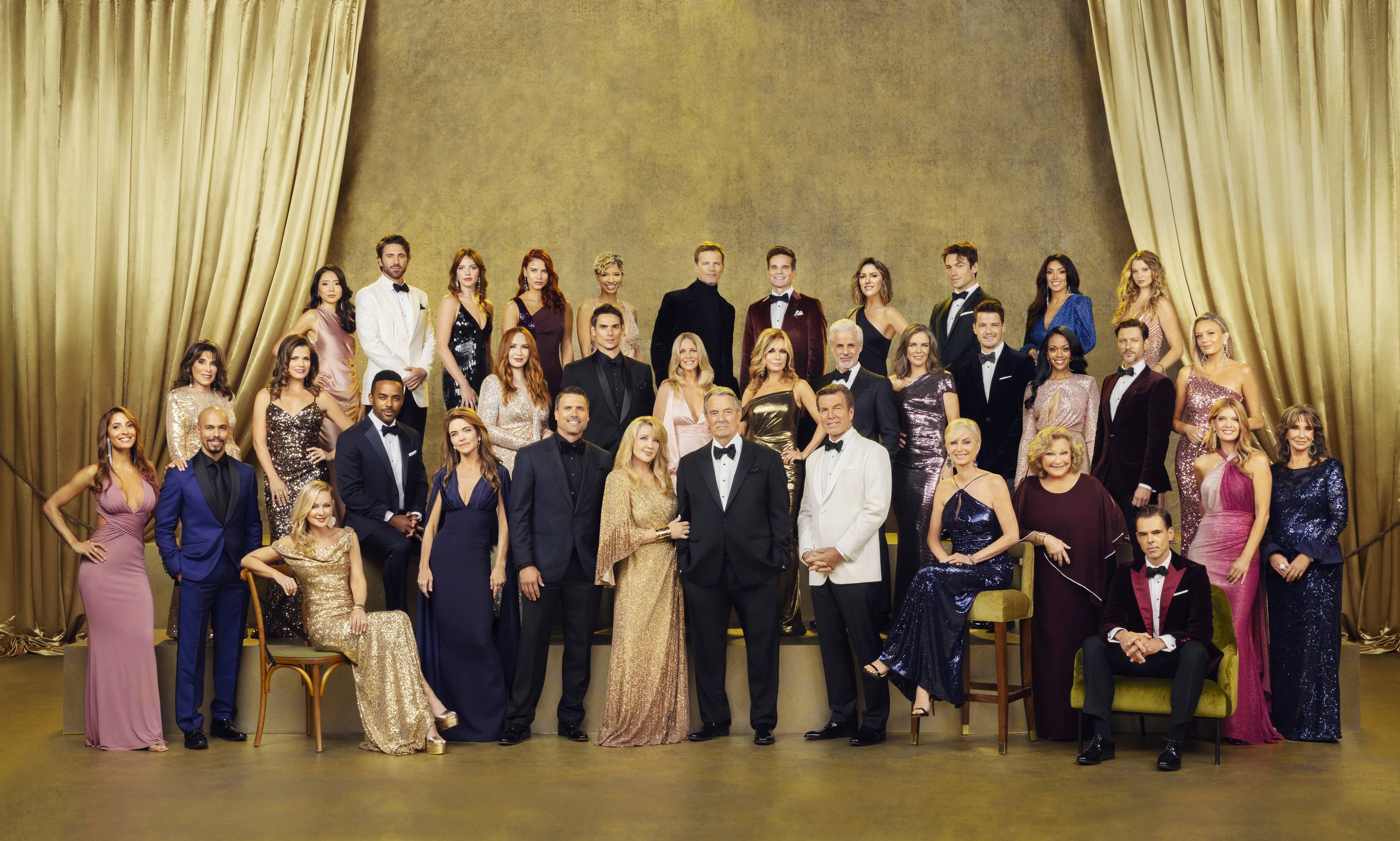 the young and the restless cast stand in front of gold backdrop
